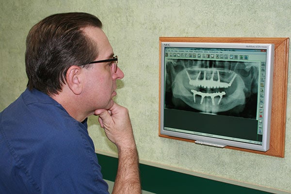Dr. Glenn Wolfinger examines an x-ray