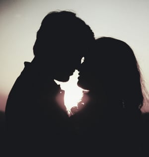 Kissing couple in profile for Valentine's Day blog.