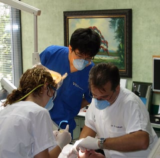 Dr. Glenn Wolfinger and dental assistant treat a patient at Pi Dental Center while intern observes Dr. Glenn Wolfinger and dental assistant treat a patient at Pi Dental Center while intern observes